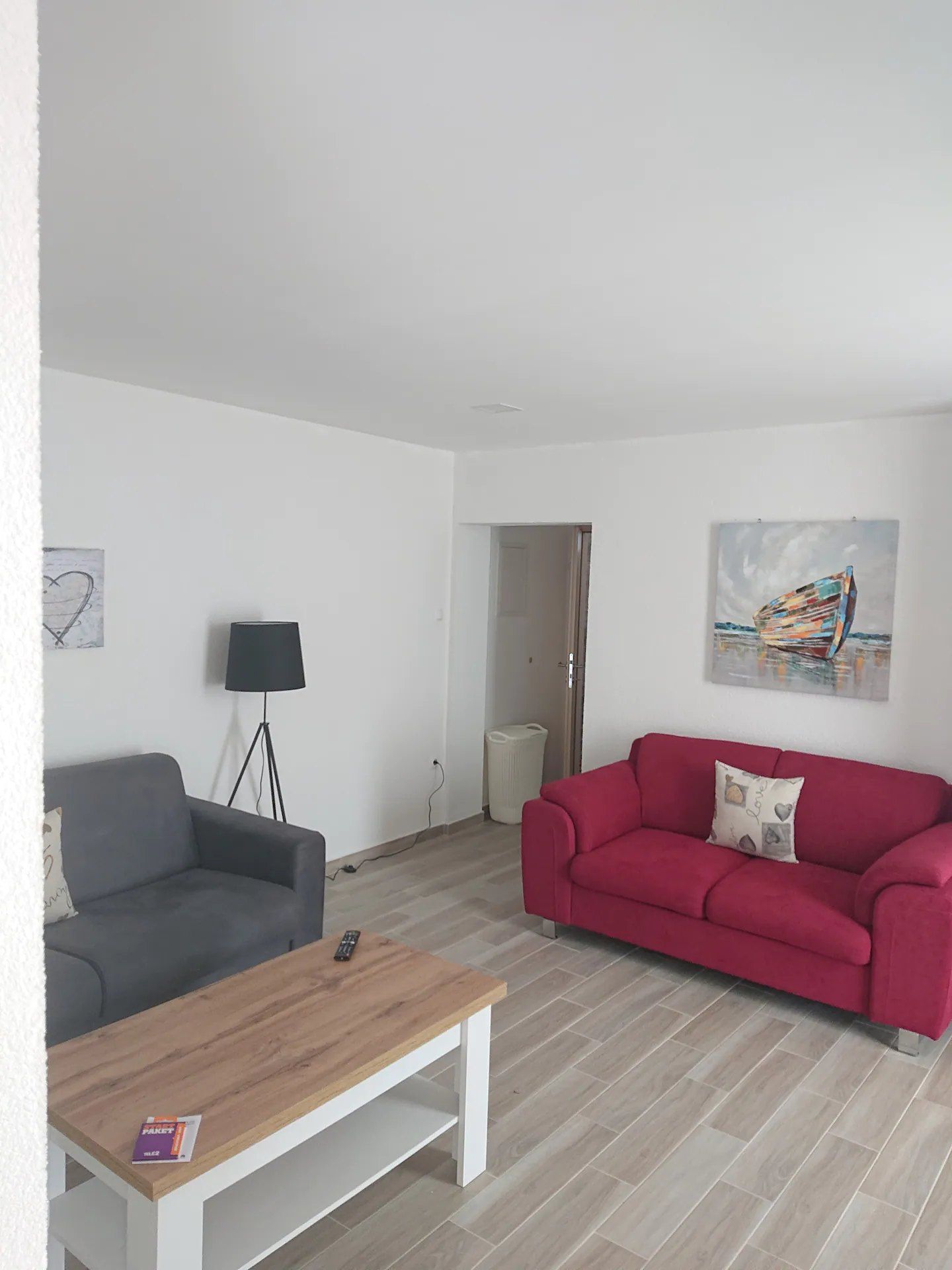 Corner of the living room with two sofas and a floor lamp